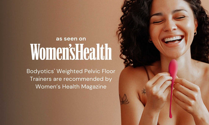 Woman smiling and holding pink Bodyotics Pear Drops pelvic floor trainer with Women's Health magazine recommendation text in background