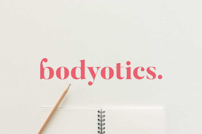 bodyotics logo with a pencil and open notebook on a white background representing Kegel Exercises guide for women