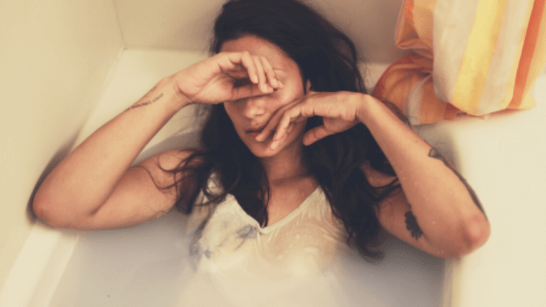 Woman resting with eyes covered, illustrating discomfort related to prolapsed uterus symptoms