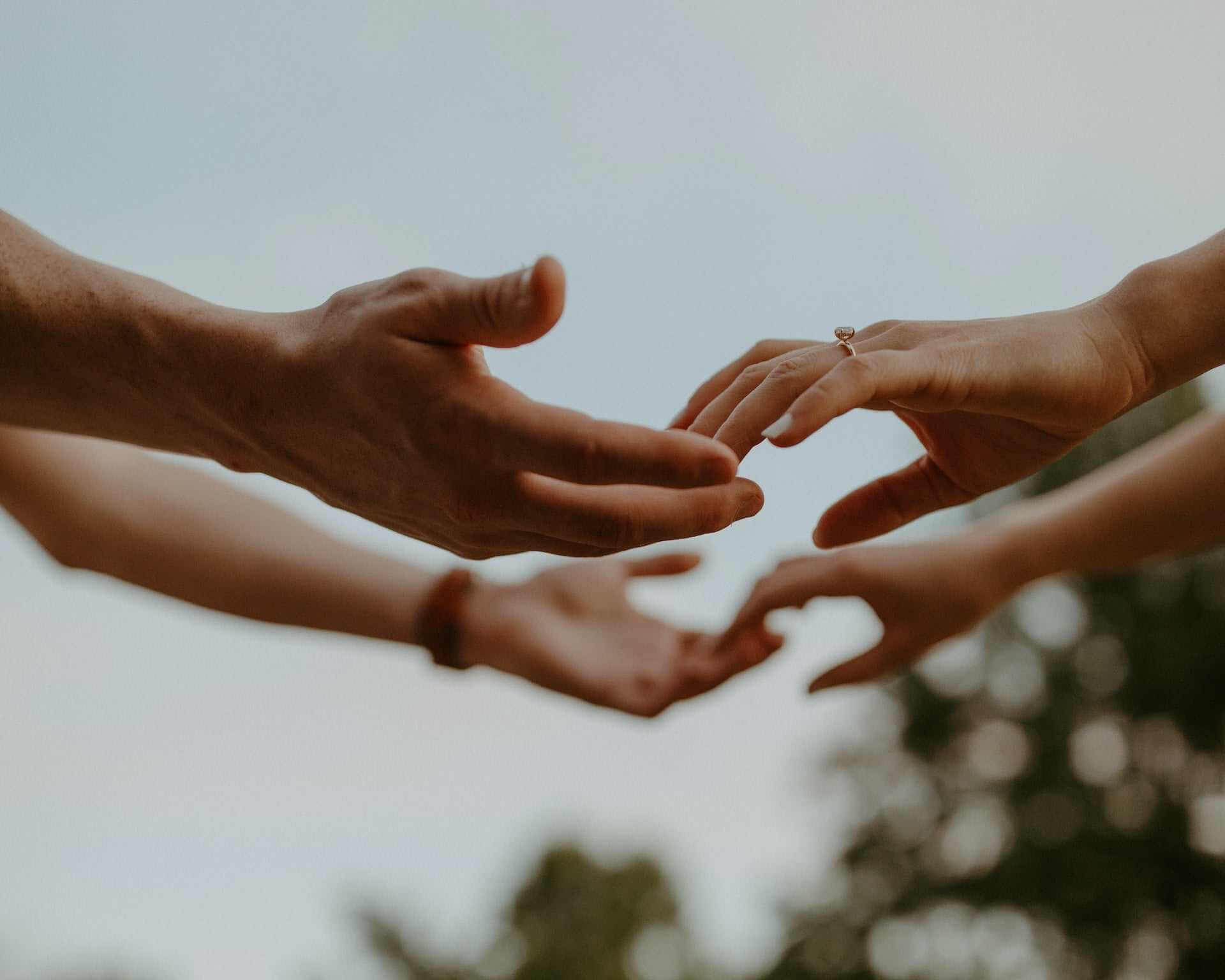 Hands reaching out to each other symbolizing connection and intimacy related to Kegel exercise benefits