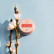 Loved candy red lip balm lifestyle model photo – woman with vibrant red lips and natural lip care