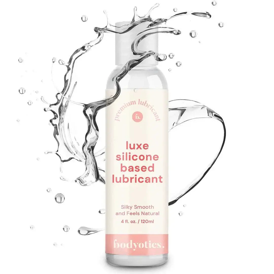 Bodyotics Premium Silicone Based Lubricant 4oz bottle with clear liquid splash, silky smooth and long-lasting formula for sensitive skin and intimate pleasure.