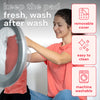 Woman using machine-washable heating pad with removable cover for easy cleaning.