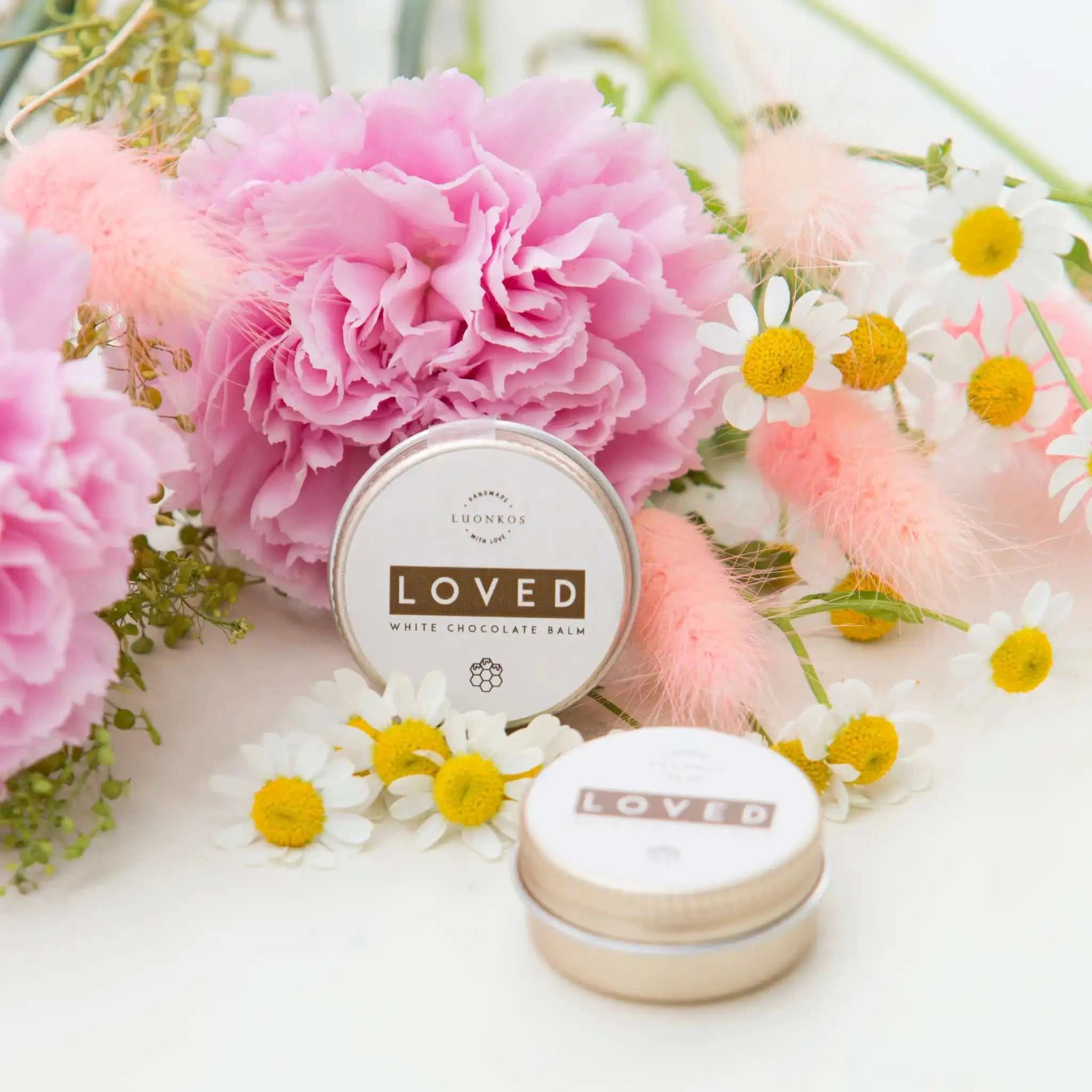Loved white chocolate lip balm lifestyle photo – woman applying natural multipurpose balm for soft lips